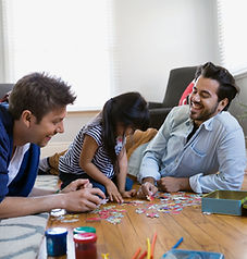 Behavior therapist and supervising BCBA working with child on a puzzle