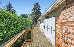Friendly caregiver guiding seniors through light exercises at Oswego Cottage, a senior care home in Lake Oswego promoting active lifestyles.