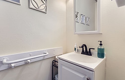 Happy resident and friendly caregiver enjoying outdoor time at Oswego Cottage, a trusted adult care home in Lake Oswego."