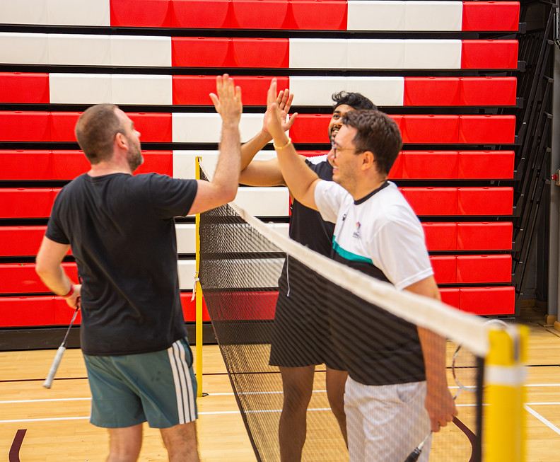 players meeting at the net to high five