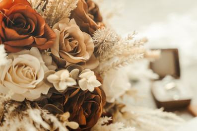 Flatlay of burnt orange and cream wedding details at Reinke Farm in Granite Falls, MN