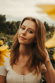 Senior photos in a sunflower field.
