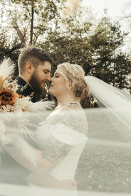 Bride and groom portraits embracing in the fields of their Minnesota wedding venue.