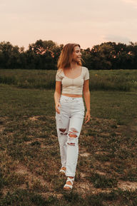 Senior photos in a sunflower field.