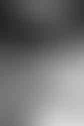 Bride holding bouquet with photo charms honoring loved ones.