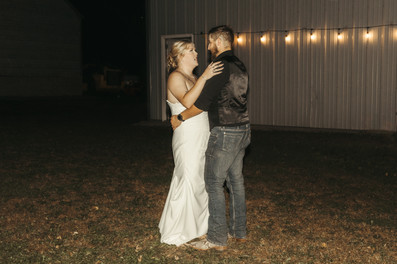 Bride and groom dancing under string lights at Granite Falls, MN wedding.