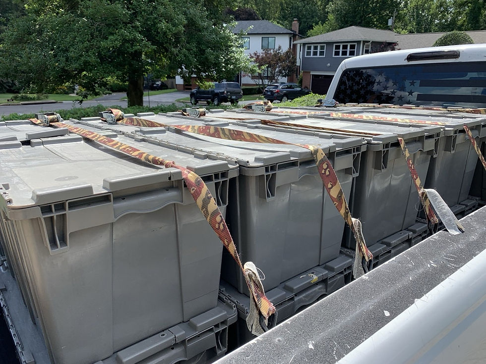 local-book-pickup-gray-totes-loaded-in-truck-bed