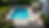 High angle view of an above ground pool deck with outdoor kitchen and seating area