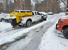 Salt truck de-icing a commercial lot