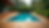 Eye-level view of a multi-level wooden deck surrounding an above ground pool with built-in seating