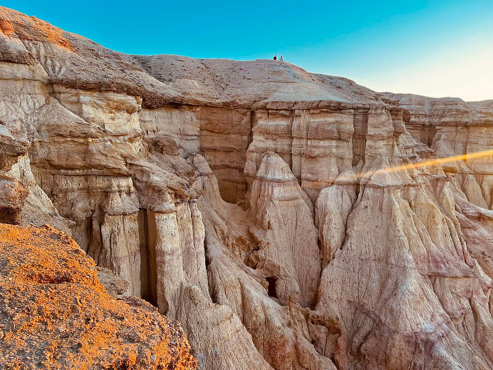 Eroded white-and-orange limestone cliffs in the Gobi