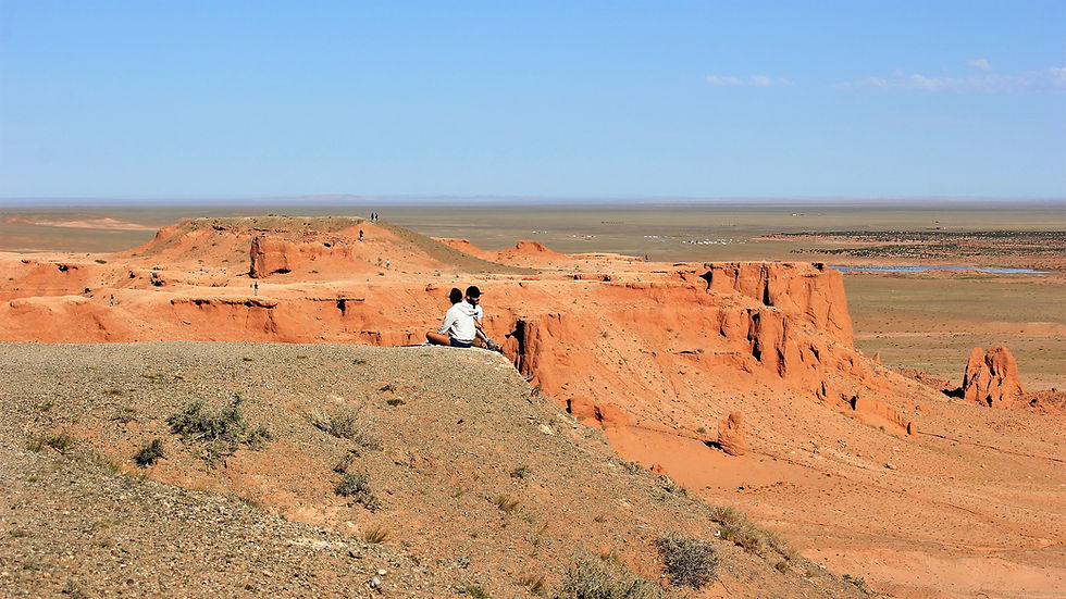 A stunning view of the red cliffs of Bayanzag, Mongolia, against a clear blue sky
