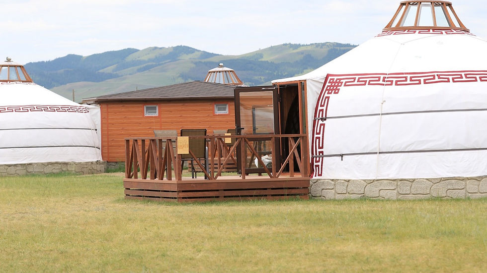 Nomadic ger tent on the Mongolian steppe at golden hour.
