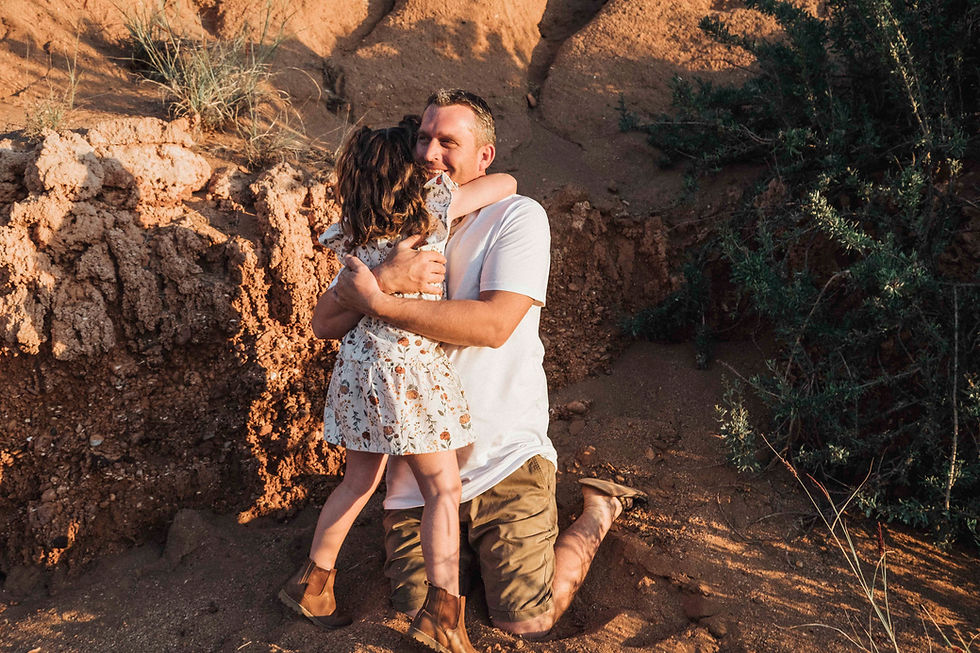 Father and daughter embracing in a pilbara outdoor enviroment