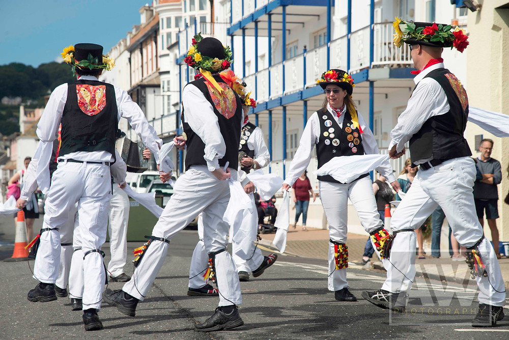 Morris Dancers perform for the crowds during Sidmouth FolkWeek at Sidmouth in Devon.