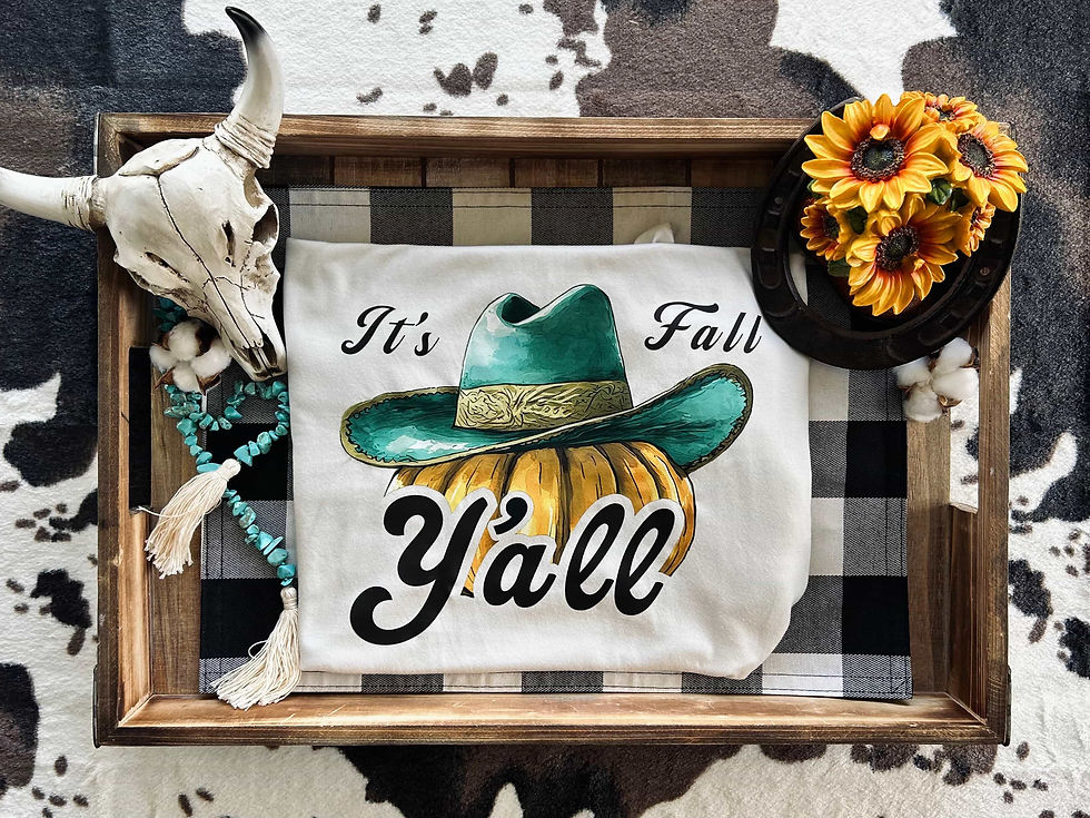 A graphic tee featuring a pumpkin wearing a cowboy hat with the phrase "It's Fall Y'all," perfect for autumn celebrations.