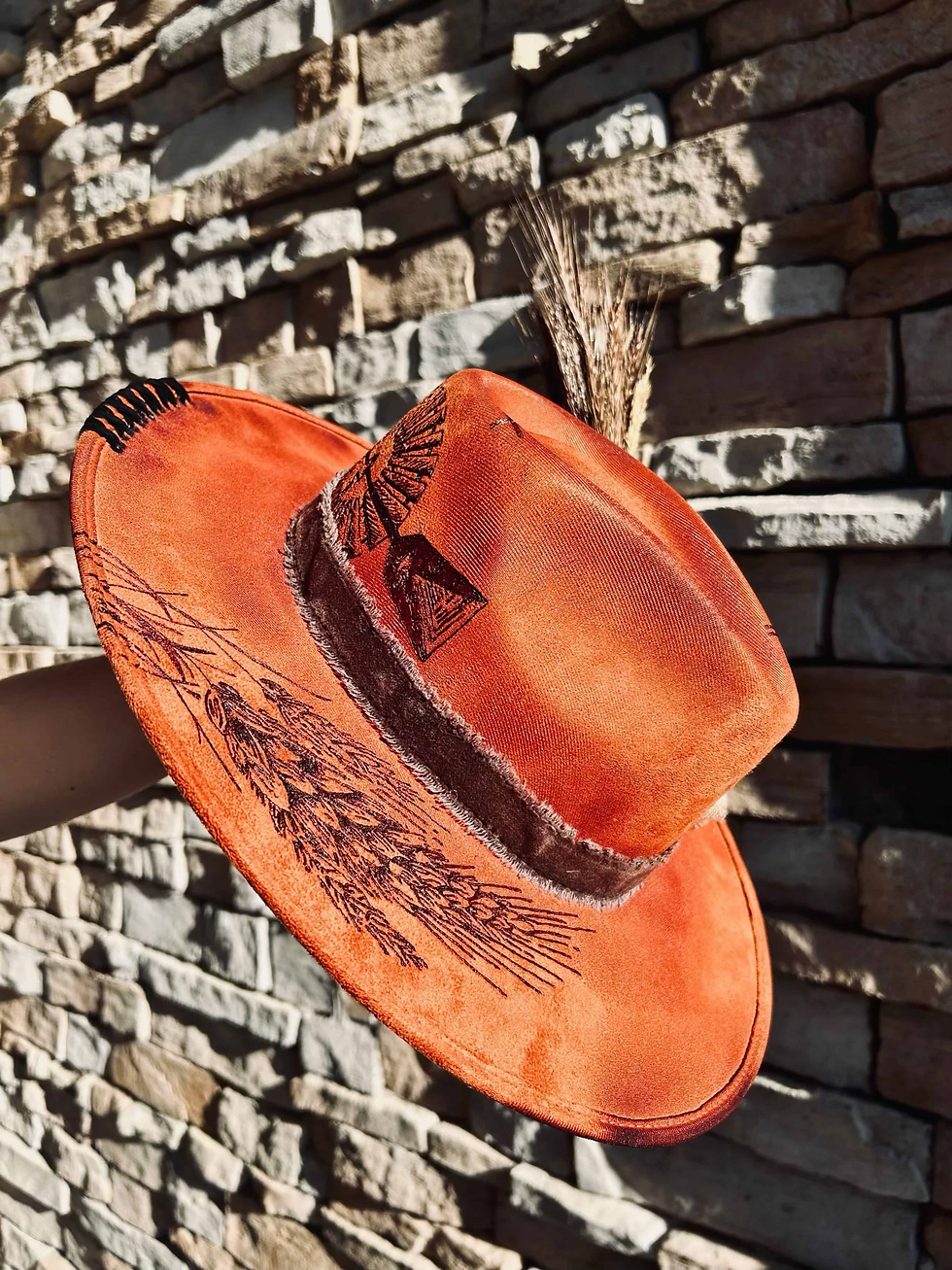 Thumbnail: A hand burned hat from Happy Harvest Co. with wheat design and windmill with wheat and ribbon around hat.