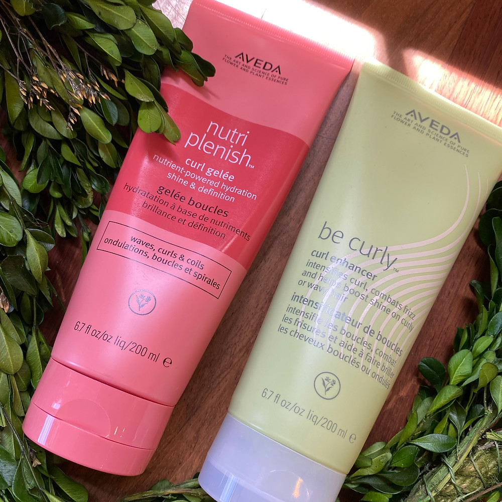 Nutriplenish Curl Gelee and Be Curly Curl Enhancer products with green boxwood garland