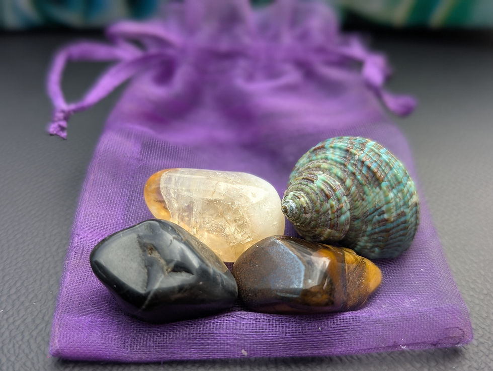 Crystals and a small shell resting on a purple pouch, part of a portable sanctuary kept in the car.