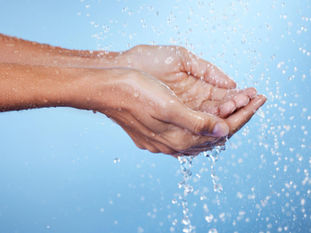 Hands catching splashing water