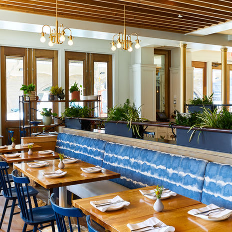 Custom blue banquette and wood tables at Wildseed restaurant in San Francisco