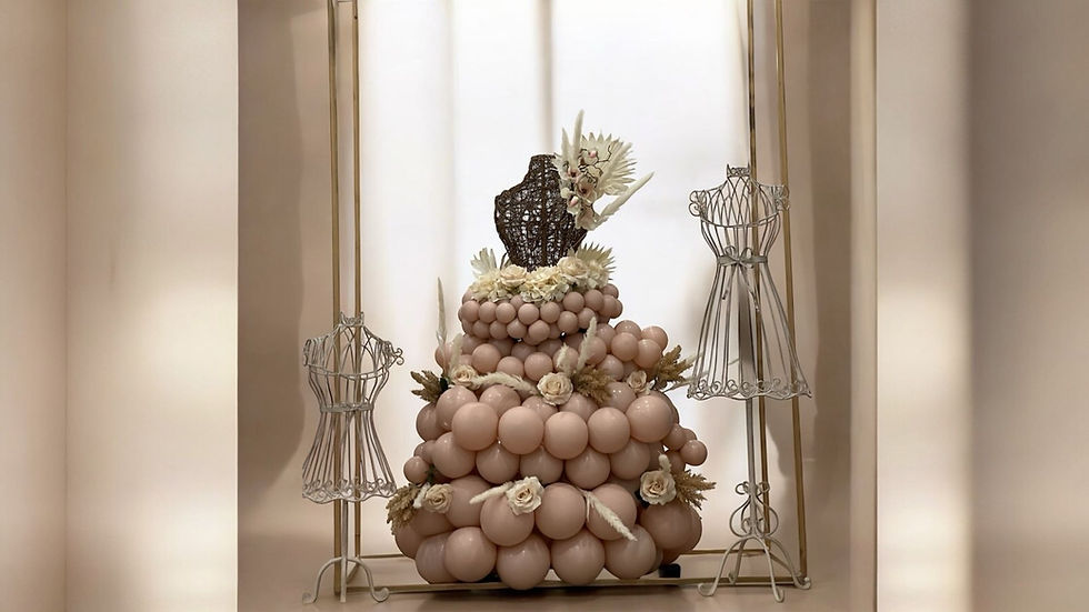 Female-shaped stand with flowers styled as a dress with an elegant balloon garland, custom event décor by Party and Co. Event Styling in the GTA