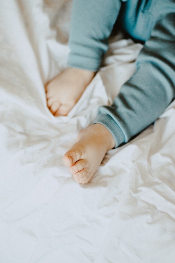 baby feet in a bed | The Peaceful Sleeper