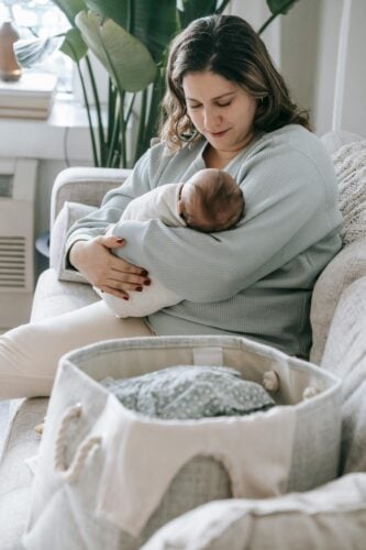 Mom Holding Baby | The Peaceful Sleeper