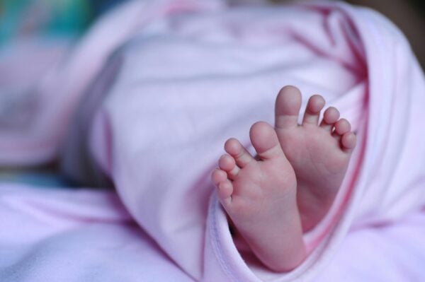 Newborn Feet in a Pink Swaddle | The Peaceful Sleeper