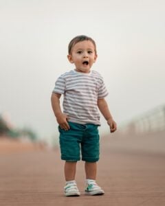 24 month old boy standing in a striped shirt | The Peaceful Sleeper