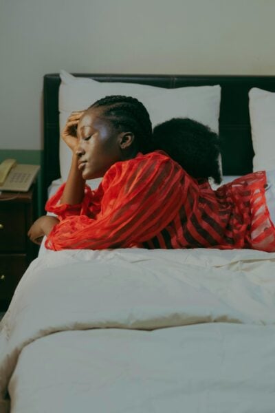 Mom Sitting on Bed | The Peaceful Sleeper