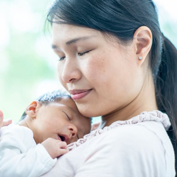 a mother practicing attachment parenting with her baby | The Peaceful Sleeper