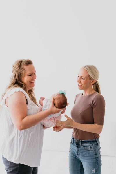 a sleep consultant talking to a mother holding her baby | The Peaceful Sleeper