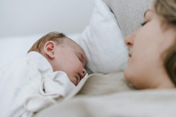 Mom Holding Baby | The Peaceful Sleeper