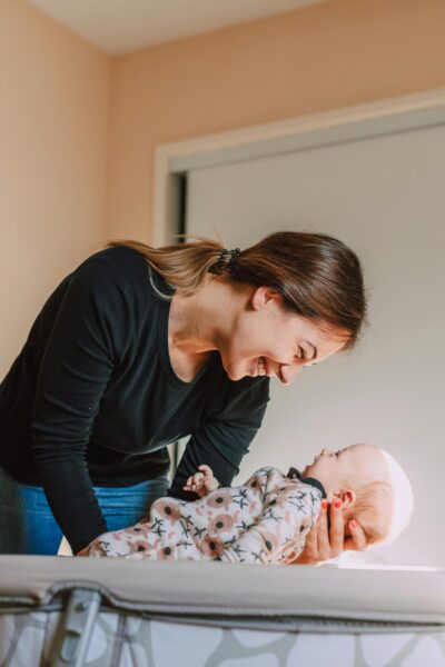 Mom Holding Newborn | The Peaceful Sleeper