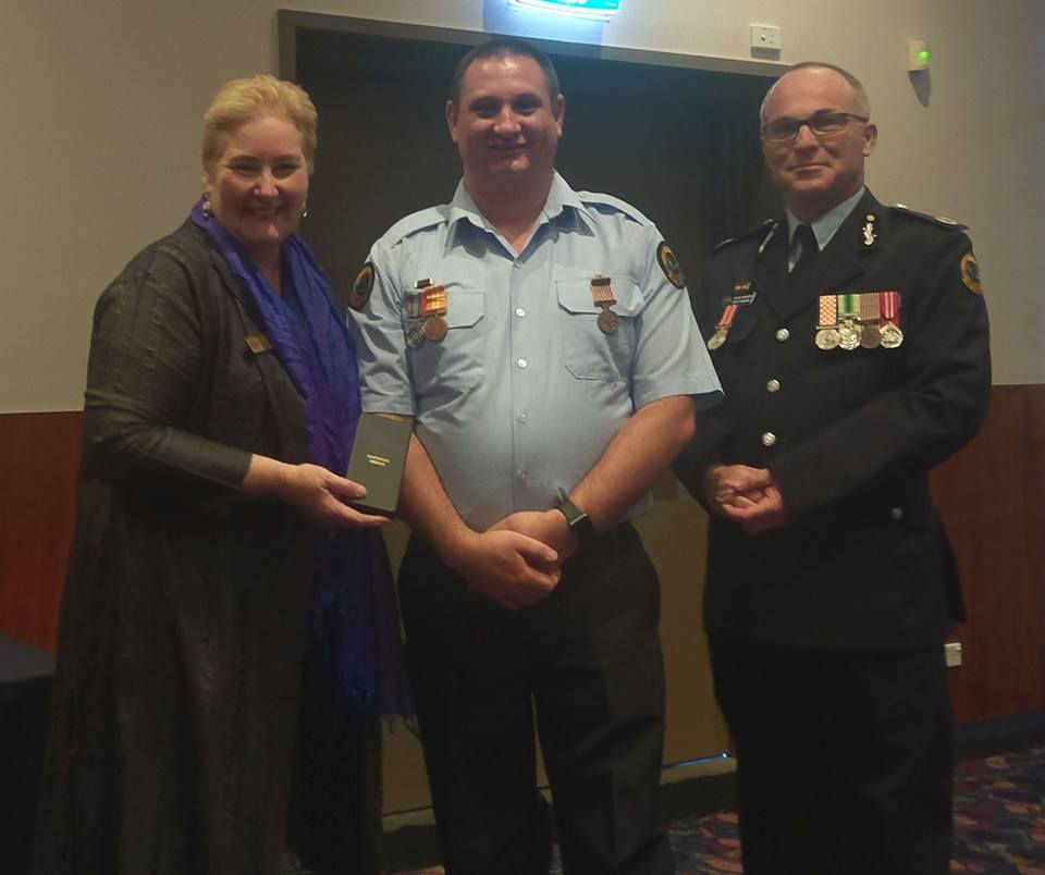 Ann Sudmalis MP and Assistant Commissioner Scott Hanckel pressent Bob Colville with his 15 year National Medal.