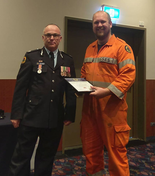Assistant Commissioner Scott Hanckel presenting Ross Garner with 5 years Long Service Award