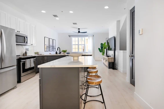 A bright kitchen with a bar counter and seating in a condo downtown Delray Beach Florida