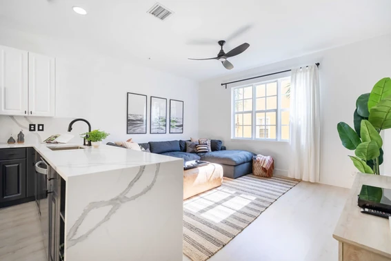 A modern kitchen and living room in a condo downtown Delray beach