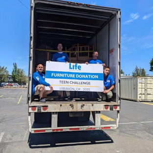 LIFE volunteers on a truck loaded with donated furniture