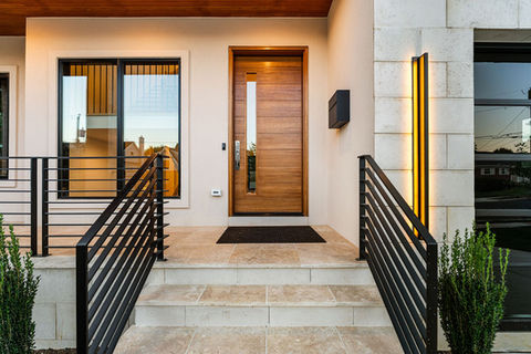 Travertine porch with 42" wide wood entry door.