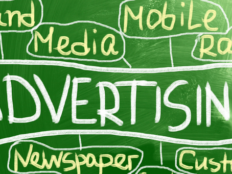 Chalkboard illustration with the word 'Advertising' in large white letters at the center, surrounded by related terms like 'Brand,' 'Media,' 'Mobile,' 'Radio,' 'Newspaper,' and 'Customer' written in yellow.
