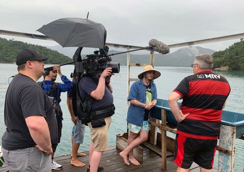 Crew filming Rodrigo Cano and Scott Fahrenkrug during a coastal scene in Paraty