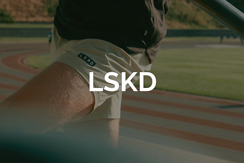 Green running and fitness shorts with fresh running track and bright green grass for Lucas Cullen's LSKD portfolio. 