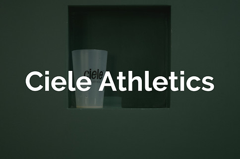 White cup with Ciele writing sitting on green ledge for Lucas Cullen's Ciele portfolio. 