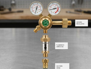 A studio-style breakdown showing an oxygen regulator, a flashback arrestor, and an oxygen hose. The three components are vertically aligned and separated to show how the flashback arrestor connects directly between the regulator and the hose. Labels identify each part.