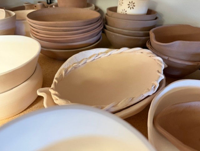 Bisque-fired bowls from The Art Center's kilns, ready for glaze and decoration.