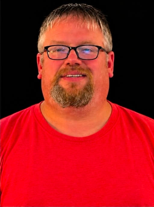 Portrait of one of our certified trainers in a red shirt