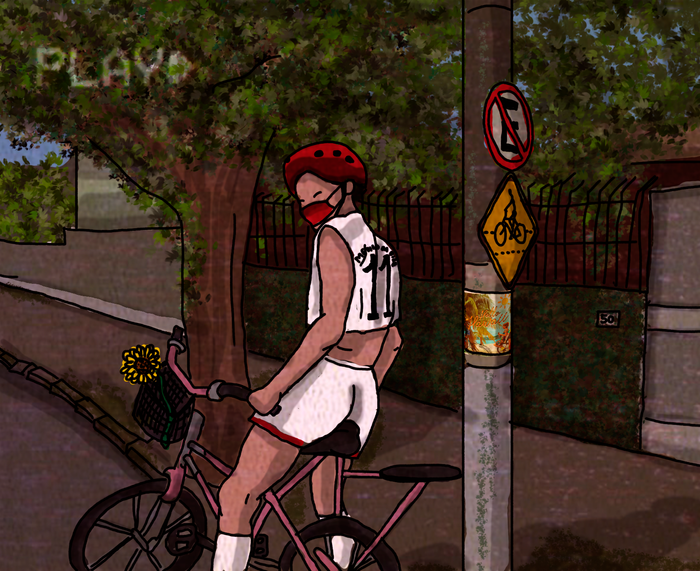 Menino sentado em uma bicicleta na rua.