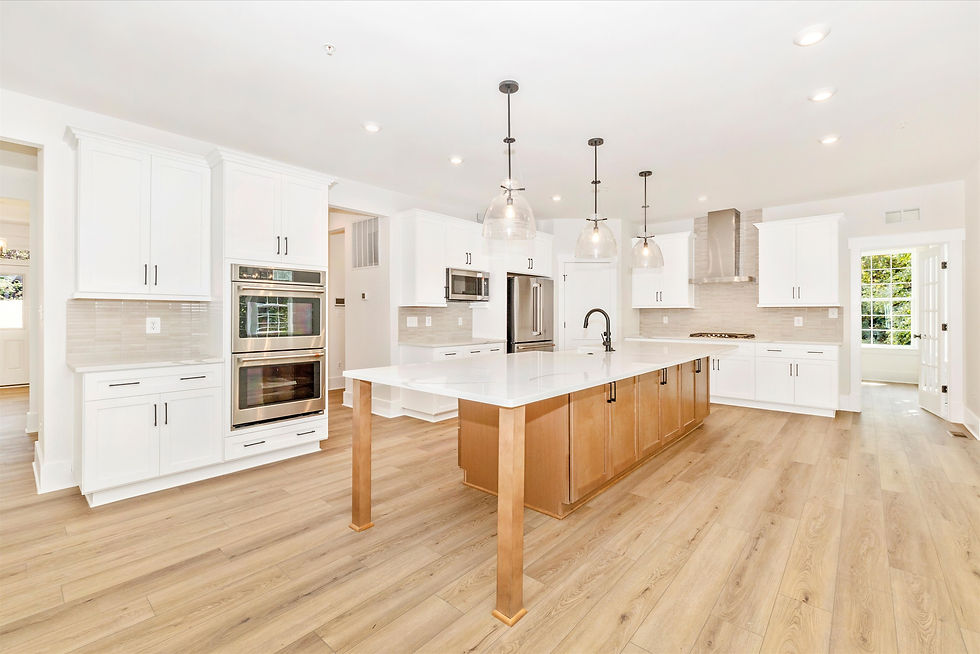Gourmet kitchen with white shaker cabinets, quartz countertops and Cafe appliances